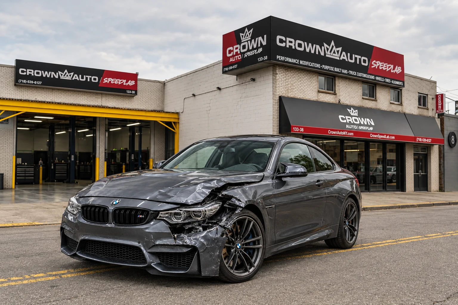 Graphite sedan with collision damage to the front bumper, hood and fender